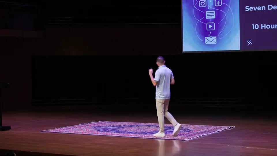 Brad Cohen walking across a stage at a business event; the slide behind him shows social, email and video icons and reads 'Seven Deliverables' and '10 Hours'.